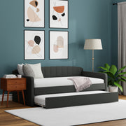 Modern living room with a gray sofa bed, wooden side table, and abstract wall art.