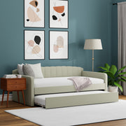 Light sofa bed in a room with abstract art on the wall, a lamp, and a plant.