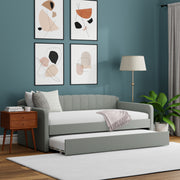 Gray sofa bed in a room with abstract art on the wall and a lamp.