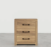 Wooden nightstand with three drawers on a light gray background